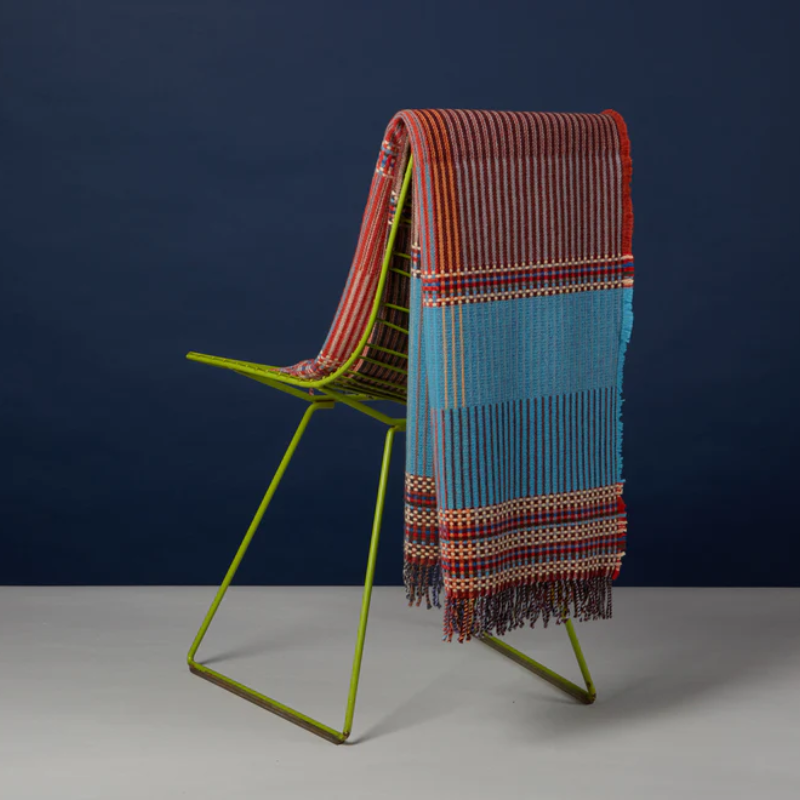 Wallace & Sewell’s Beatrix Pinstripe Throw on a chair.