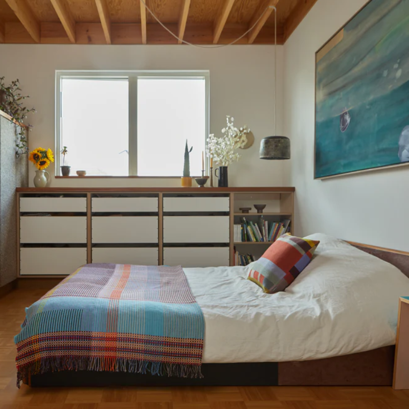 Wallace & Sewell’s Beatrix Pinstripe Throw in a bedroom.