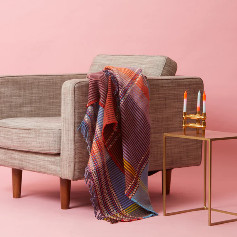 Wallace & Sewell’s Beatrix Pinstripe Throw on a chair.