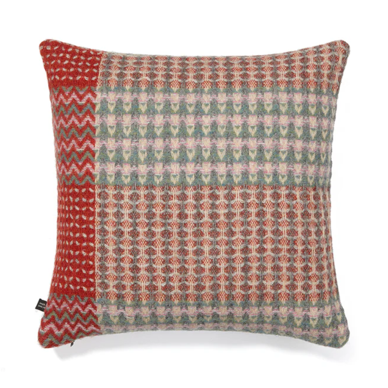 The Bryce Cushion by Wallace & Sewell. Made of 100% Shetland Wool. Cushion with muted sage green, pink, and red border.