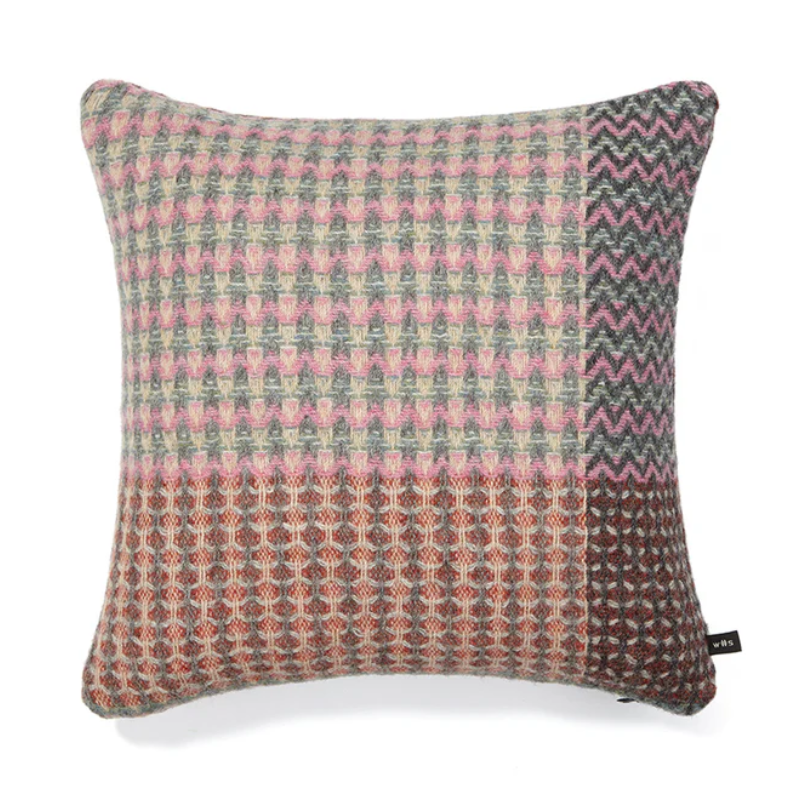 The Bryce Cushion by Wallace & Sewell. Made of 100% Shetland Wool. Cushion with muted sage green, pink, and red tones.
