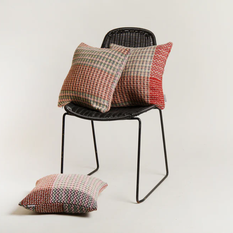 Three variations of the Bryce Cushion by Wallace & Sewell on a chair.