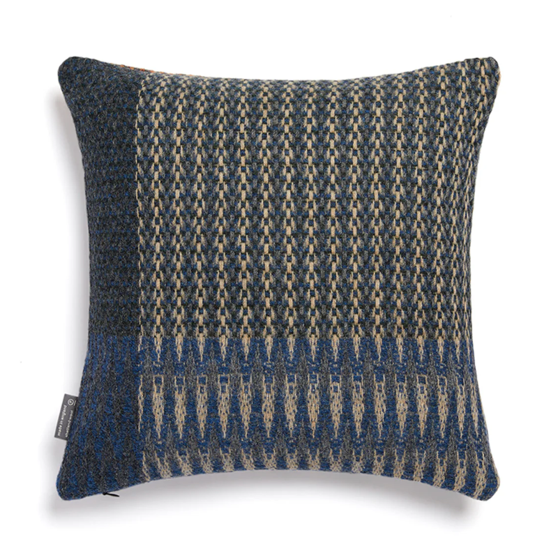 Textured pillow with blue and beige pattern.