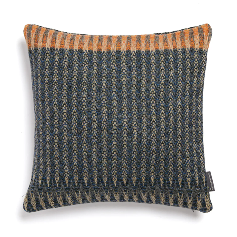 The Cairngorm Shetland Tweed Cushion is a textured pillow with orange and blue pattern.