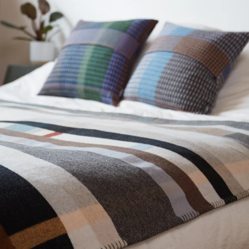 The Chipperfield Throw from the Wallace & Sewell Block Throw in a bedroom.