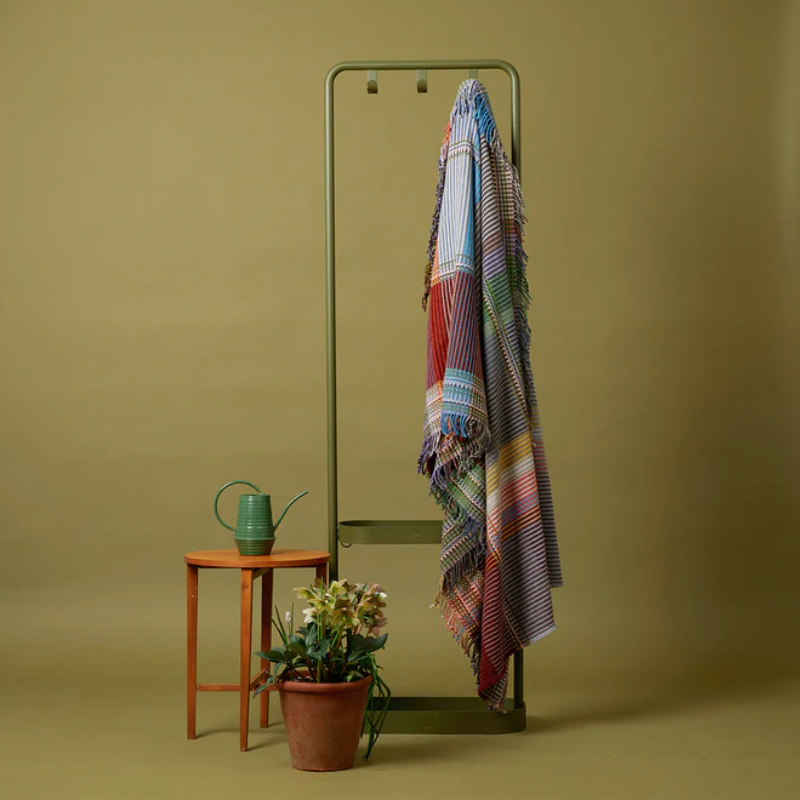 The Joan Throw by Wallace and Sewell hanging on a hook.