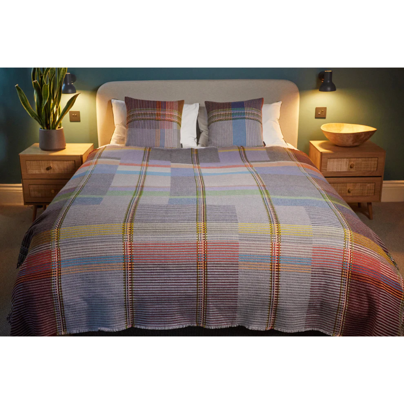 The Joan Throw by Wallace and Sewell in size large with matching Joan Cushions on a bed.
