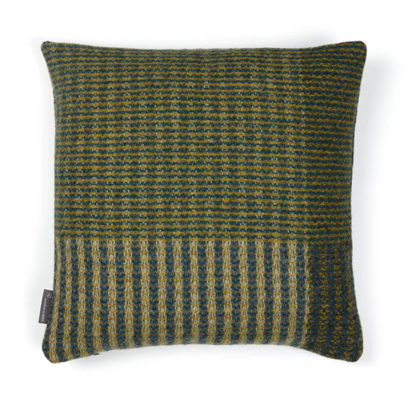 The Lismore Cushion by Wallace & Sewell features a blend of woven green and blue natural fibers.