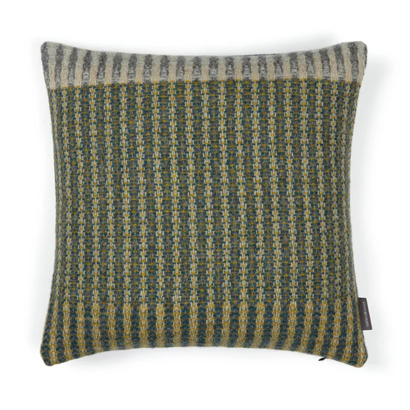 The Lismore Cushion by Wallace & Sewell features a blend of woven green and grey natural fibers.