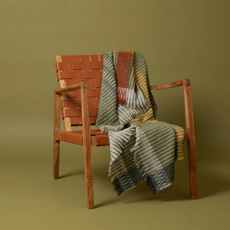 The Lismore Throw by Wallace & Sewell on an armchair.