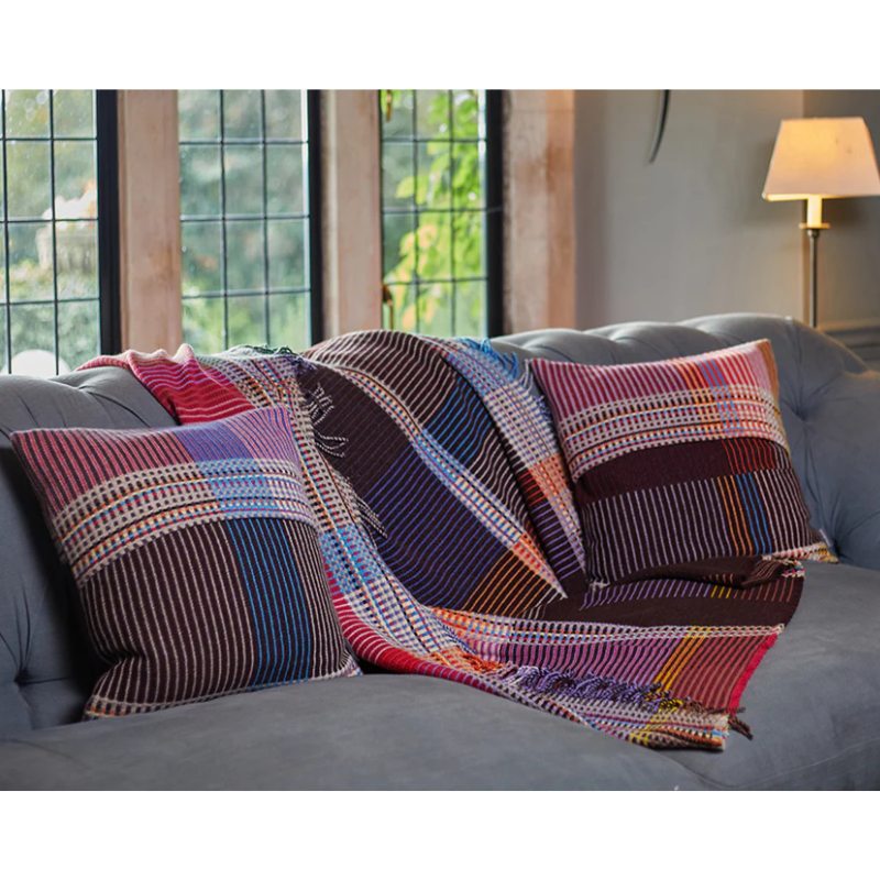 Wallace & Sewell's Pinstripe Sophia cushions and matching throw blanket on a sofa.