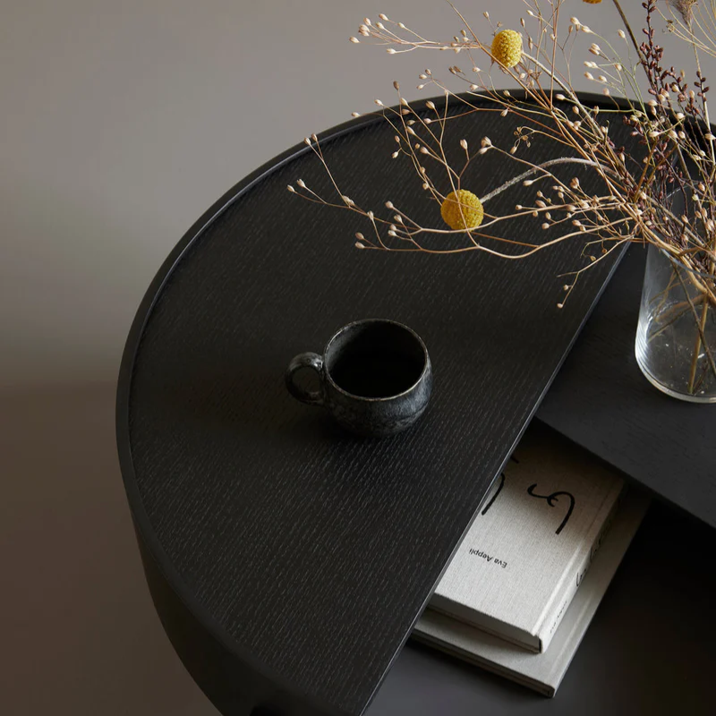 The ARC Coffee Table from Woud in black in a lifestyle.