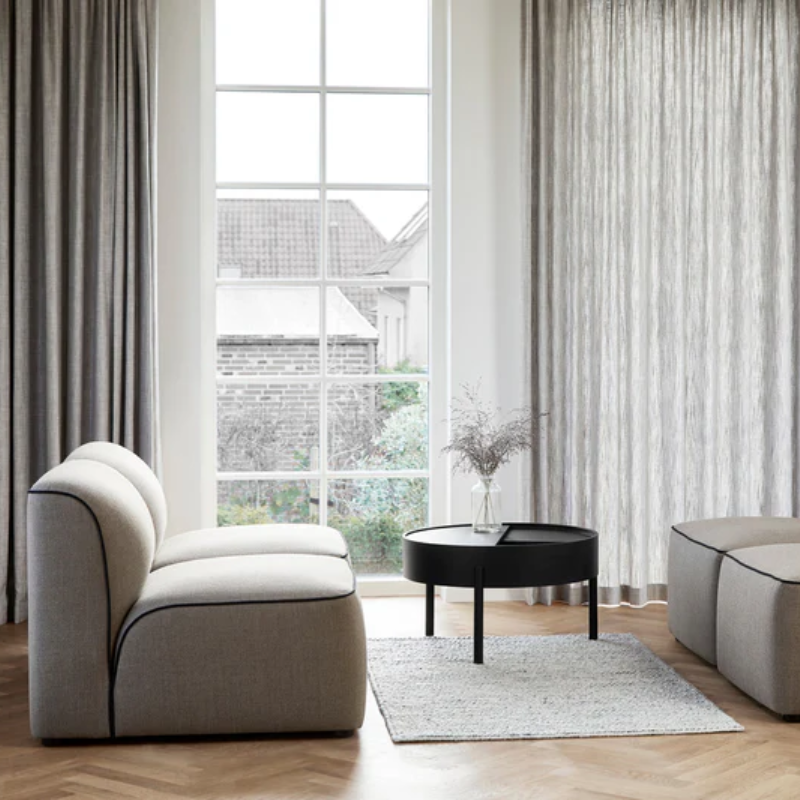 The ARC Coffee Table from Woud in black in a meeting room.