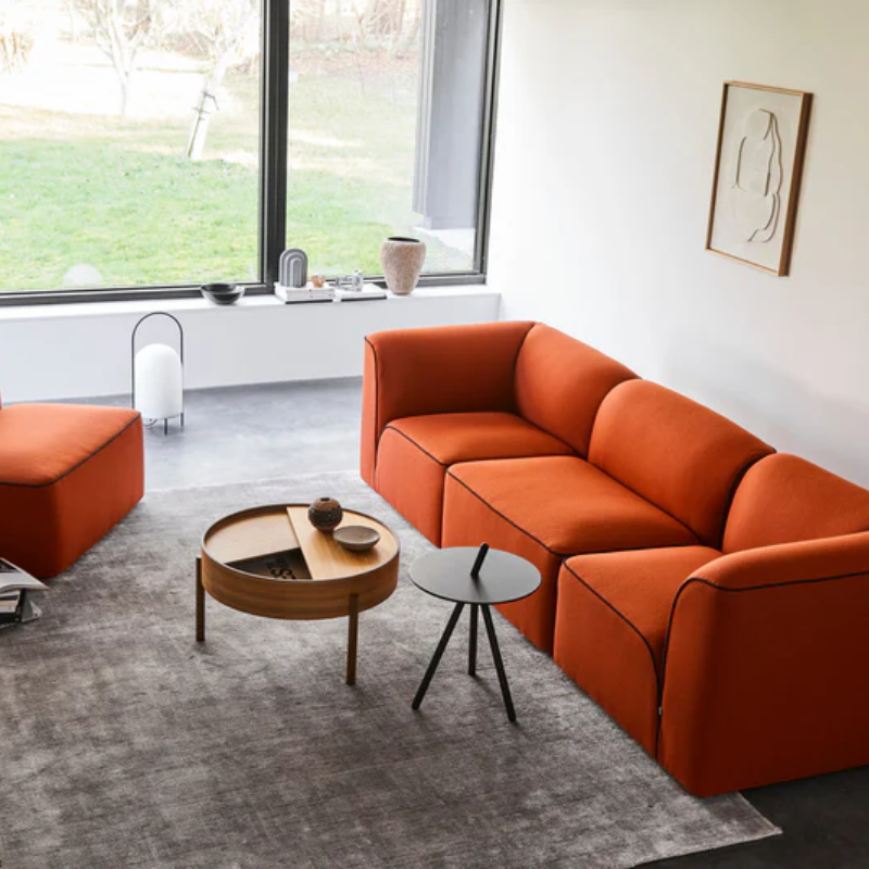 The ARC Coffee Table from Woud in walnut in a living room.
