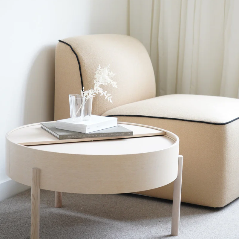 The ARC Coffee Table from Woud in white pigmented ash in a guest bedroom.