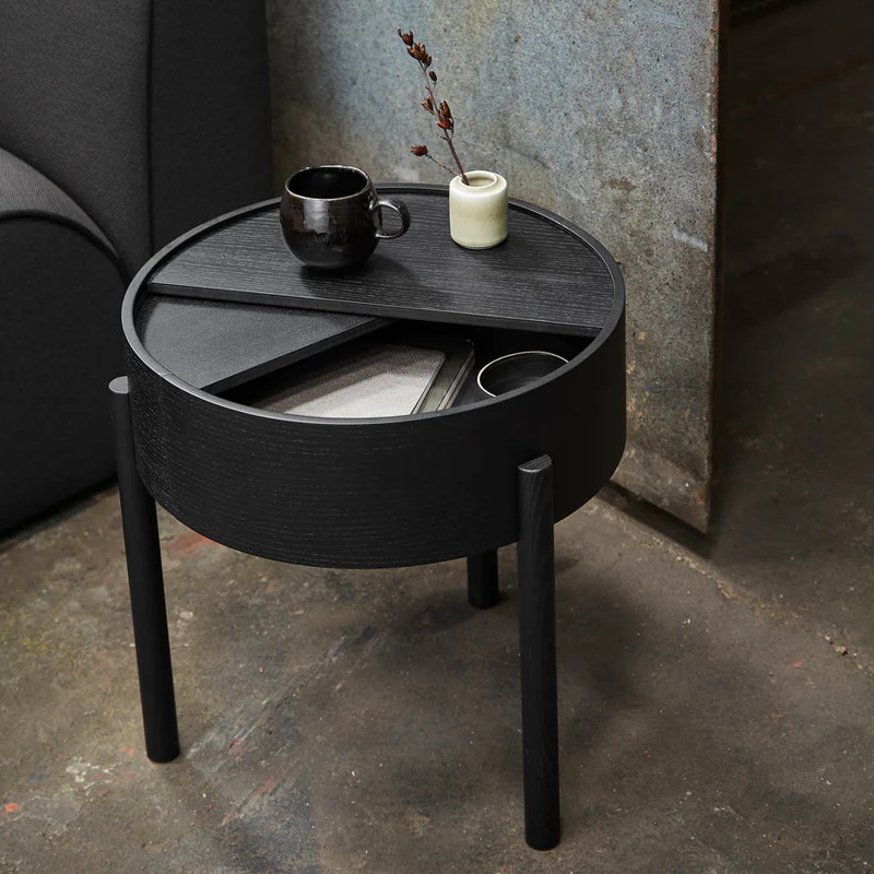 The ARC Side Table from Woud in black in a living space.