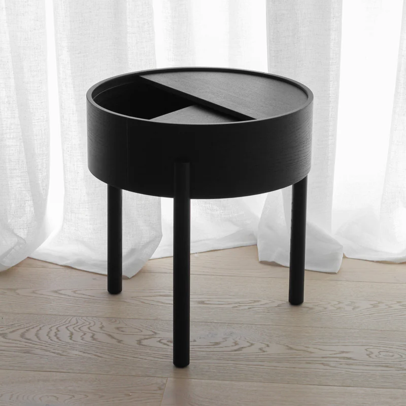 The ARC Side Table from Woud in black in a primary bedroom.