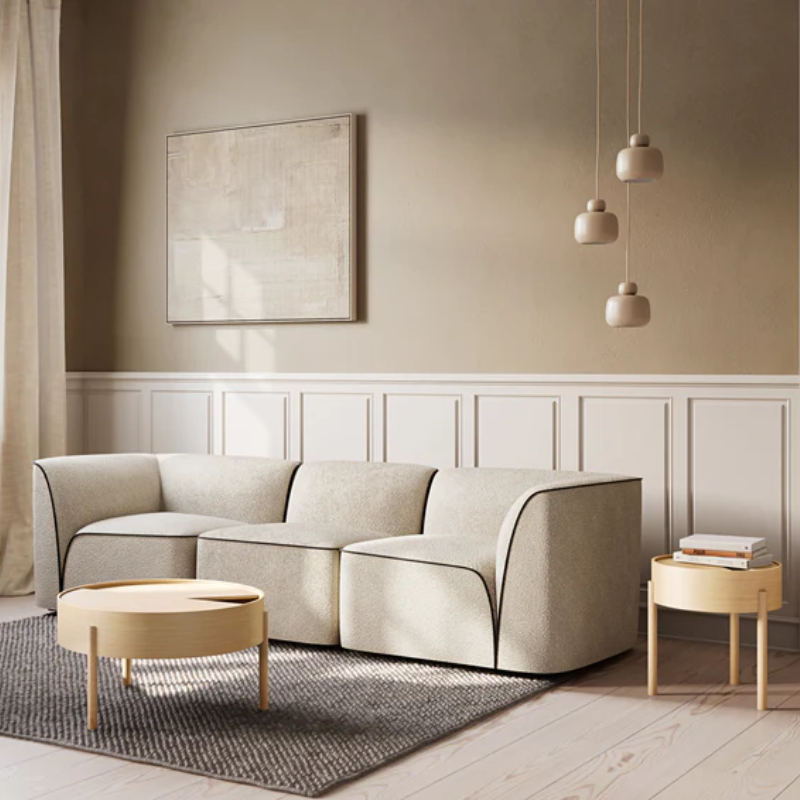 The ARC Side Table from Woud in oiled oak in a lounge.