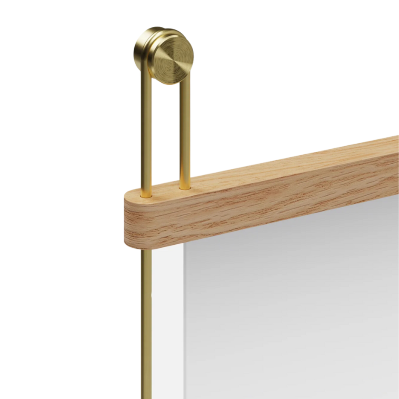 The oak frame and brass detailing of the Suspended Mirror by Woud close up. all-groups