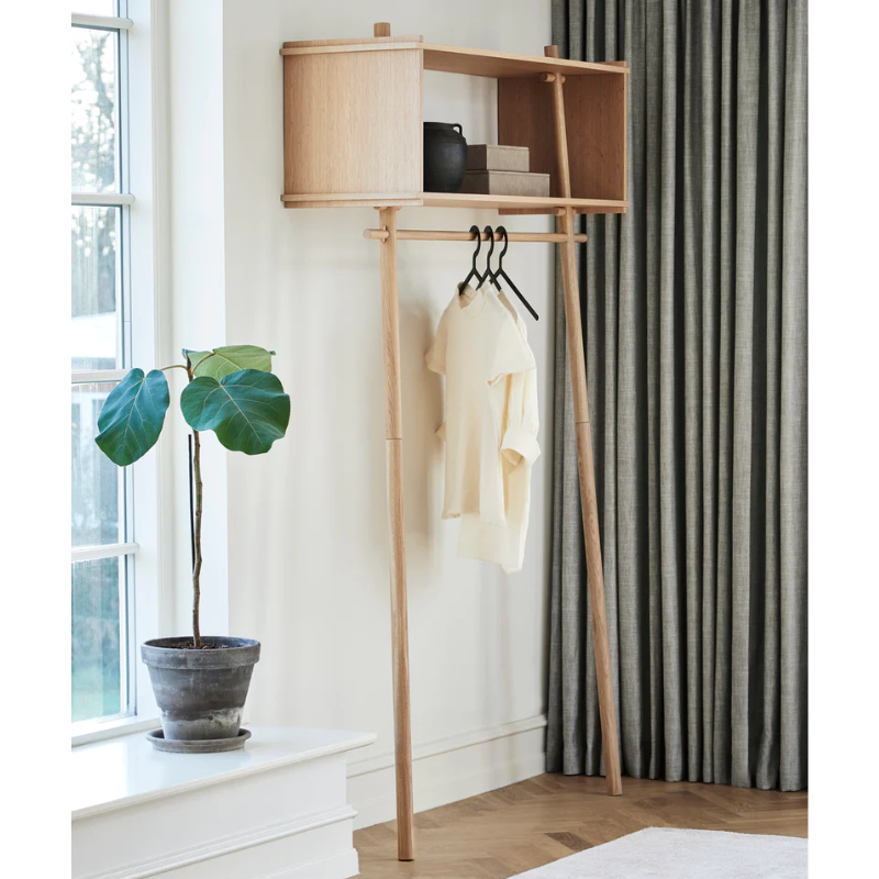The large Töjbox Wardrobe from Woud in oak in a living room.