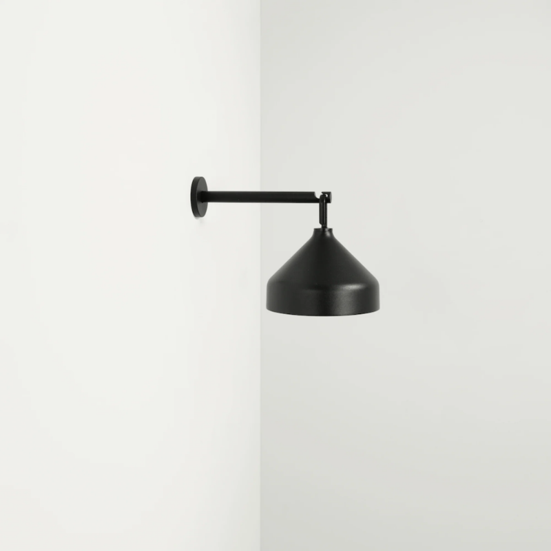 The black Amelie Pro Wall Lamp from Zafferano is wall-mounted.