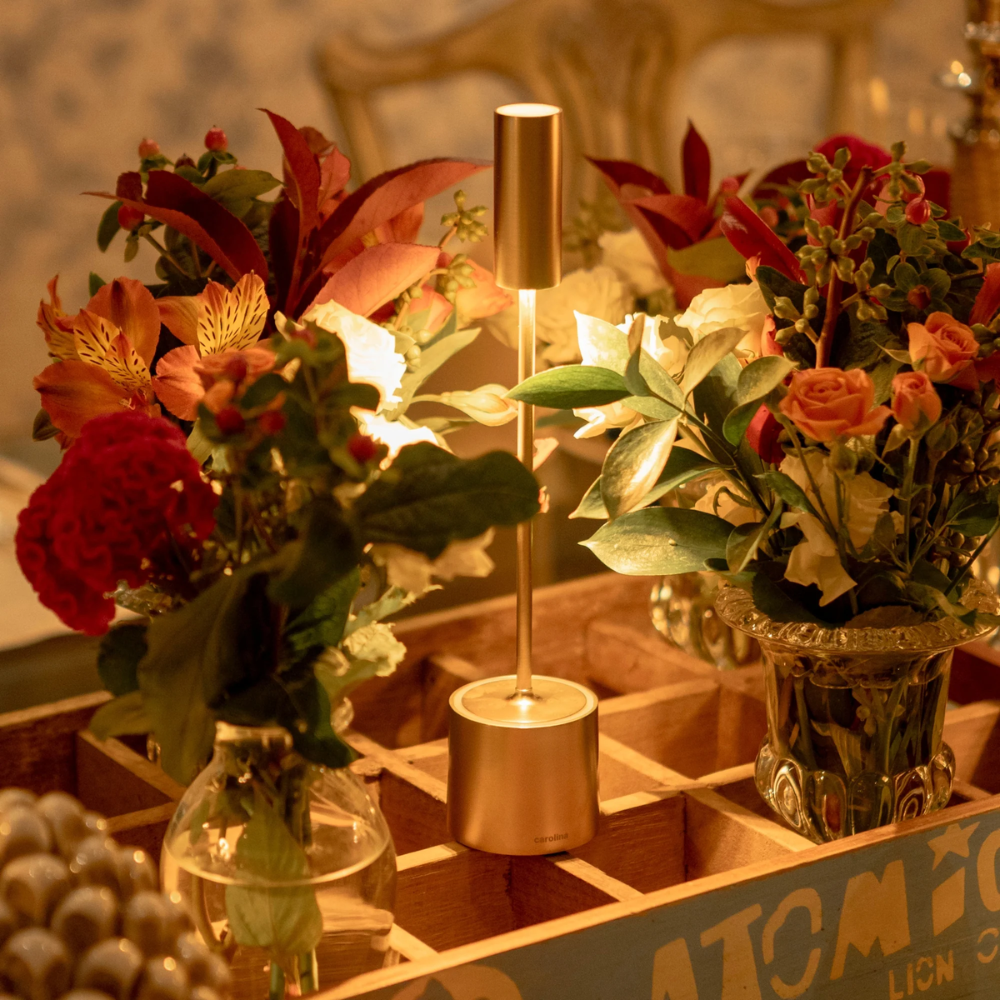 The brushed brass Carolina Pro from Zafferano on a dining table.