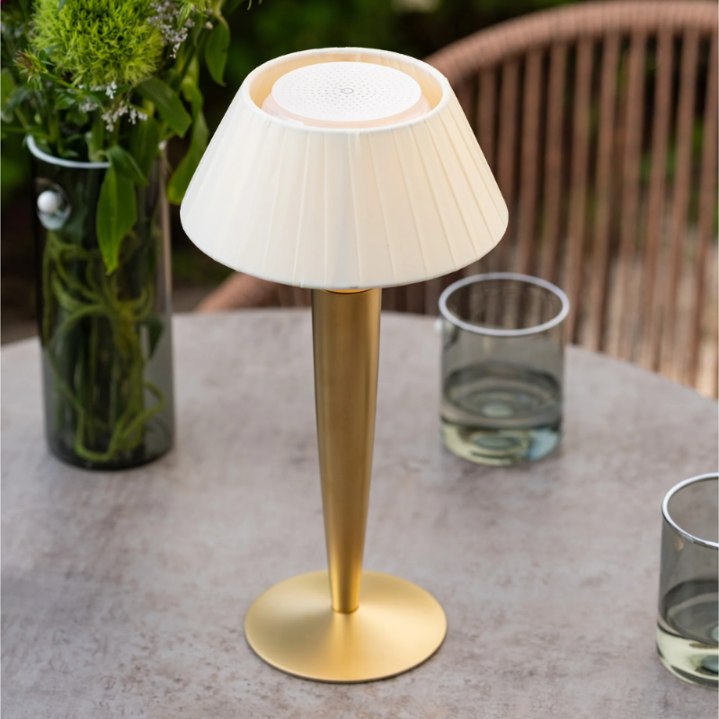 The matte gold Flaminia from Zafferano in an outdoor cafe from a top close-up.