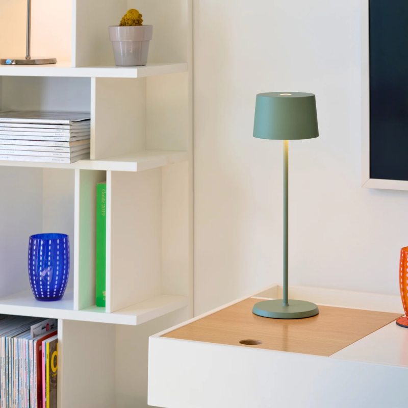 The sage Olivia Pro cordless lamp from Zafferano in a living space.