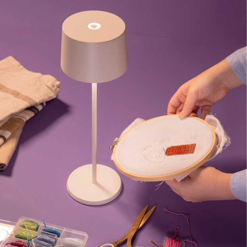 The white Olivia Pro cordless lamp from Zafferano in an activity room.