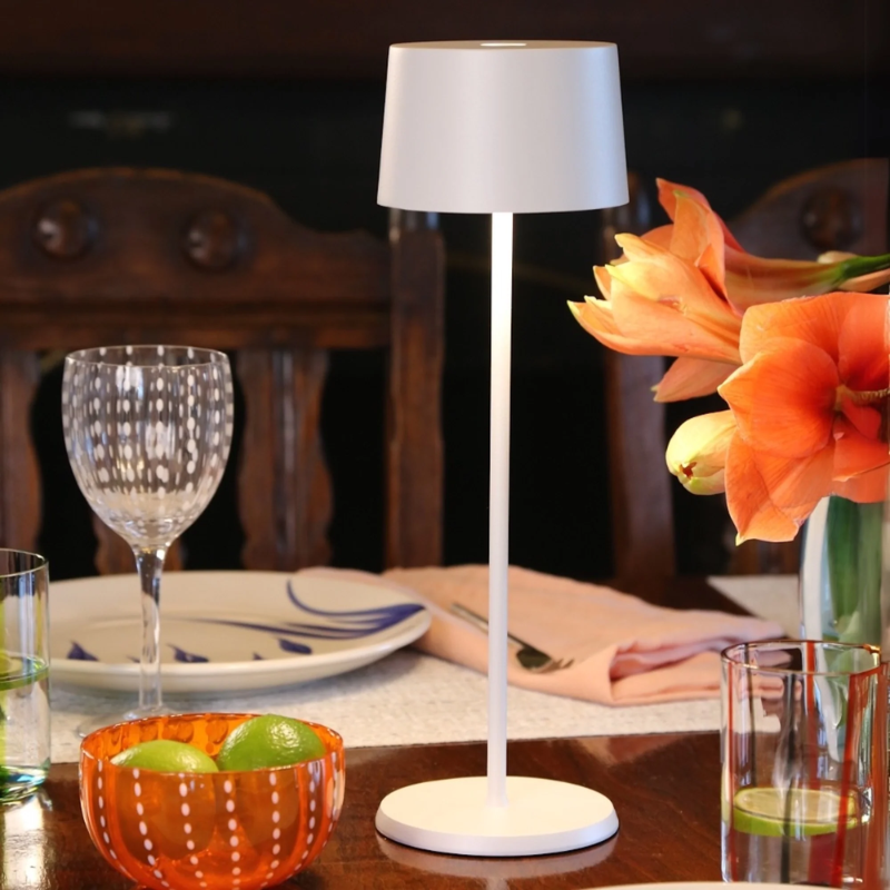 The white Olivia Pro cordless lamp from Zafferano in a dining room.
