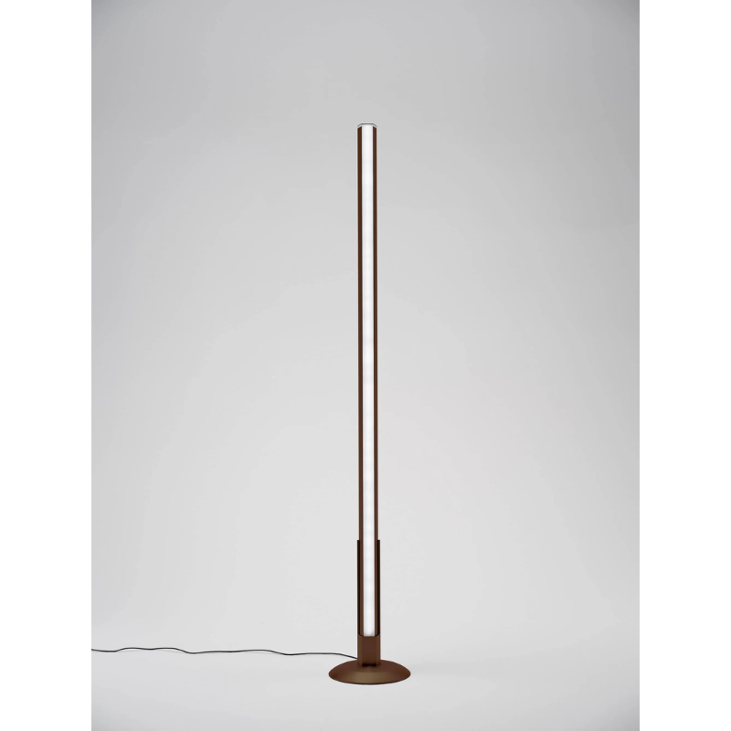 The rust Pencil Light Module with Docking Station from Zafferano in a living room.