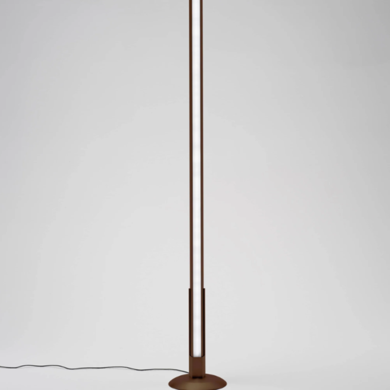 The rust Pencil Light Module with Docking Station from Zafferano in a living room.