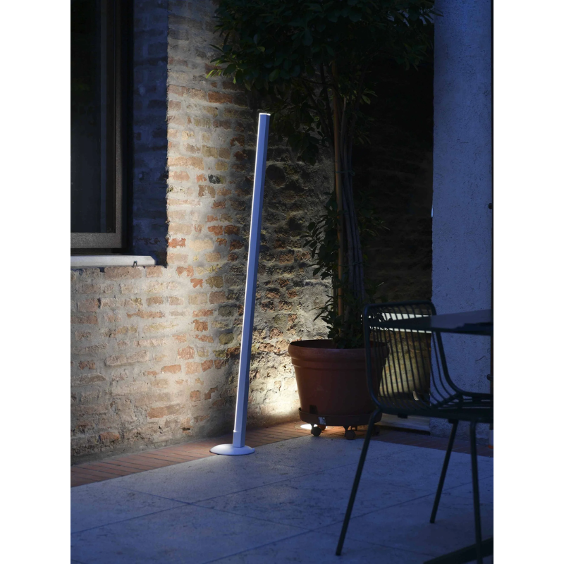 The white Pencil Light Module with Docking Station from Zafferano in an outdoor garden. all-groups
