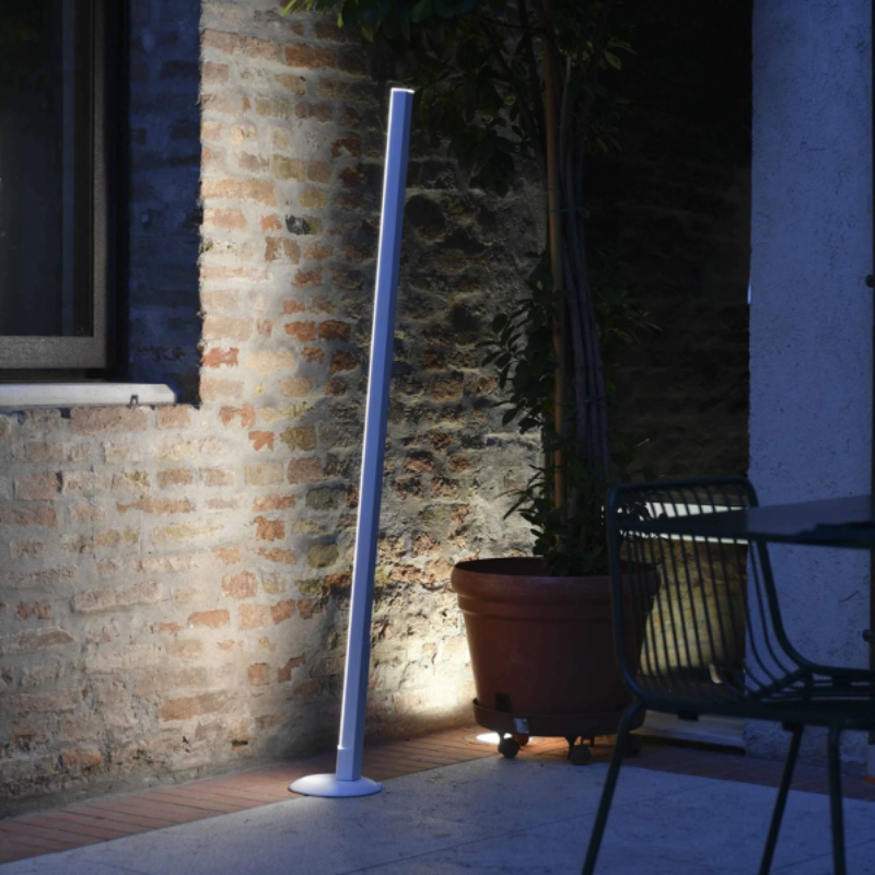 The white Pencil Light Module with Docking Station from Zafferano in an outdoor garden. all-groups
