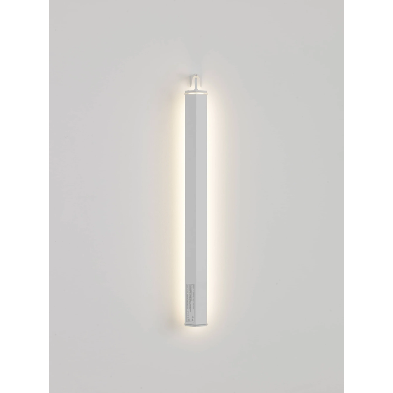 The white Pencil Light - Vertical Wall Mount from Zafferano in a living room.