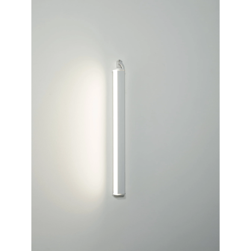 The white Pencil Light - Vertical Wall Mount from Zafferano in a studio.