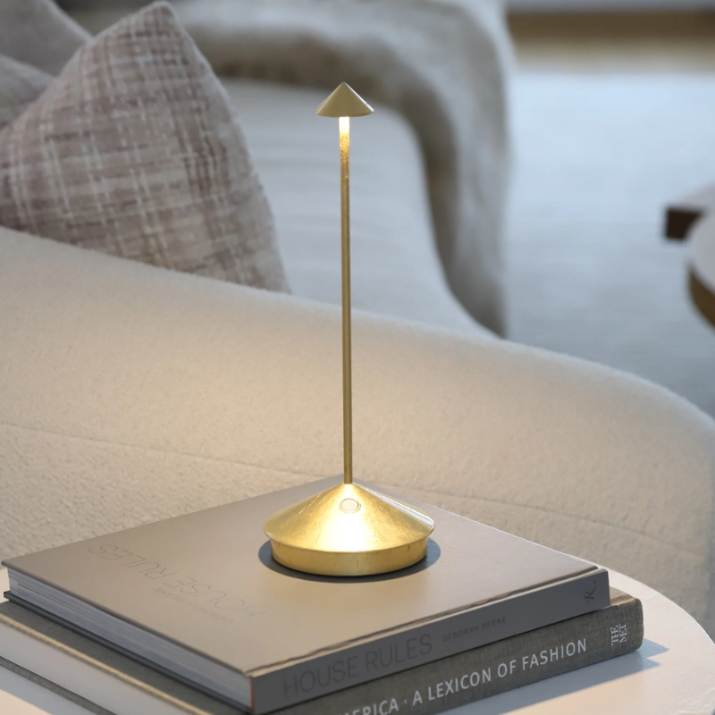 The gold leaf Pina Pro from Zafferano on an end table.