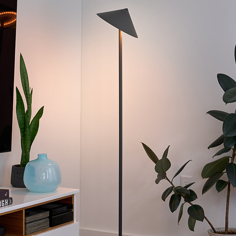 The Pina XXL Floor Lamp from Zafferano in titanium in a primary bedroom.