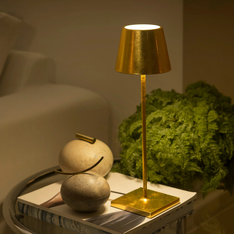 The gold leaf Poldina Pro from Zafferano on an end table.