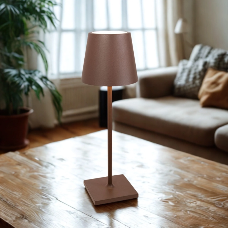 The rust Poldina Pro L Desk Lamp from Zafferano in a lounge.