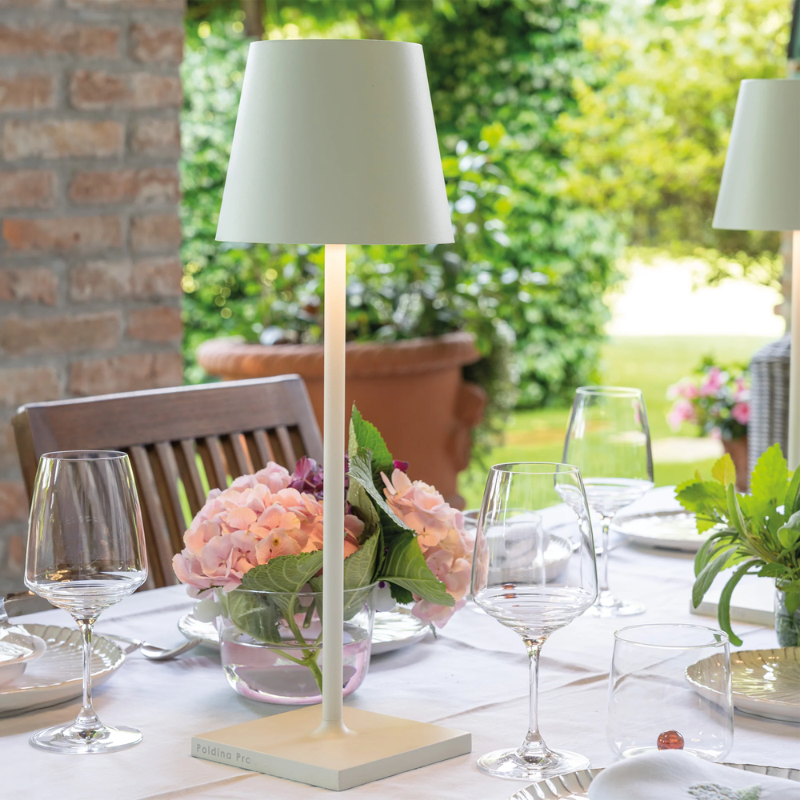 The white Poldina Pro L Desk Lamp from Zafferano on a dining table.