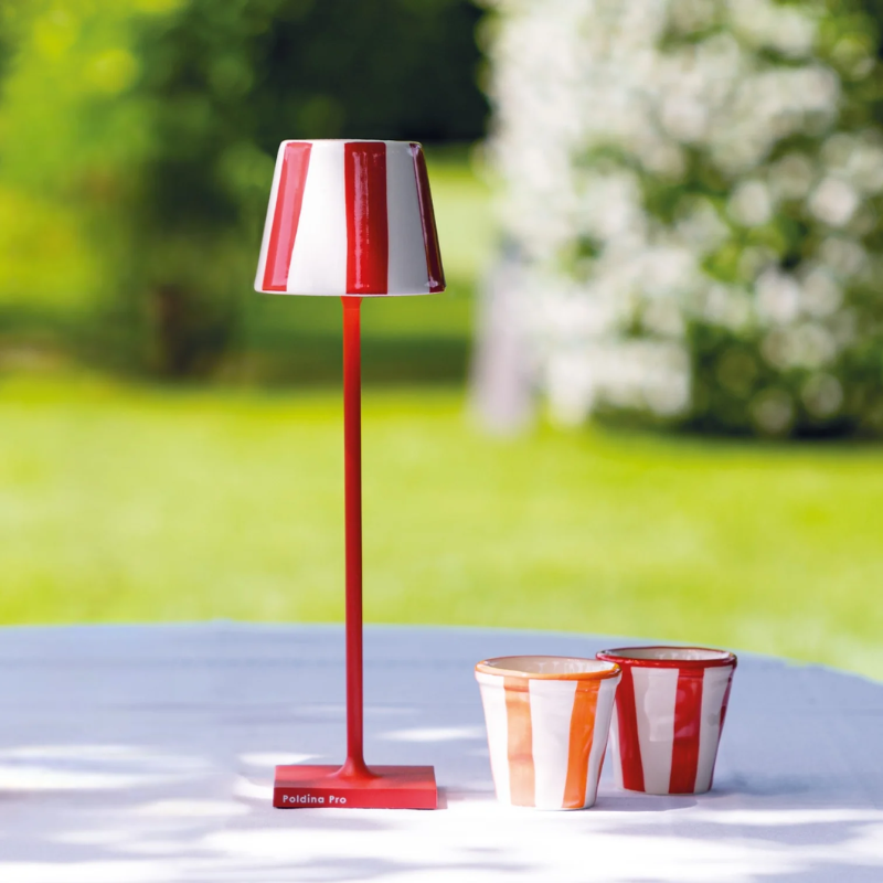 The Poldina Pro Micro Lido from Zafferano outdoors on top of a cafe table in a garden space. all-groups