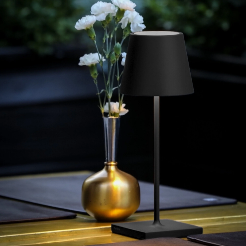 The black Poldina Pro Mini from Zafferano in an outdoor living space.