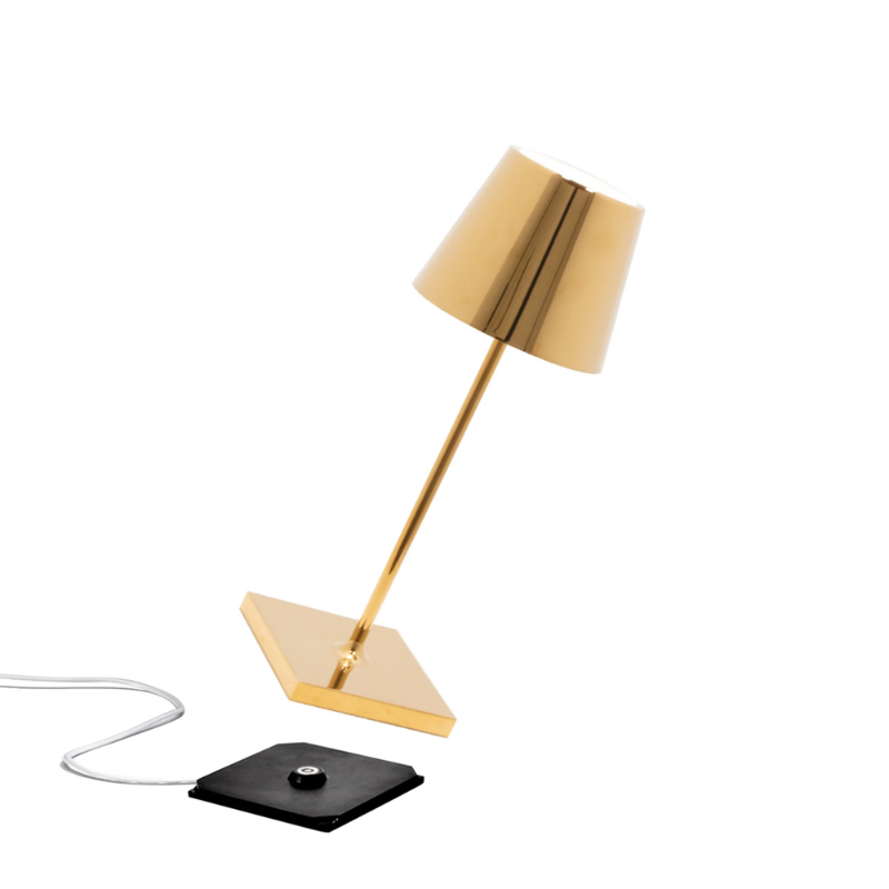 The glossy gold Poldina Pro Mini from Zafferano, a cordless lamp.