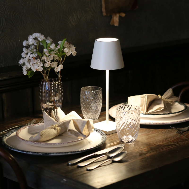 The white Poldina Pro Mini from Zafferano in a dining setting.