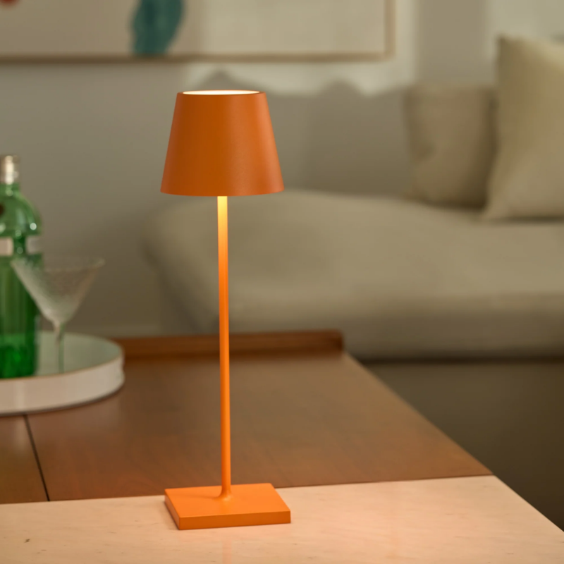 The orange Poldina Pro from Zafferano in a living room.