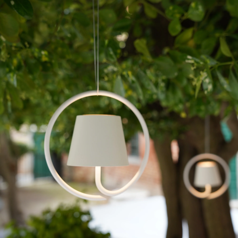 The white Poldina Pro Suspension Magnetic from Zafferano within a businesses garden.