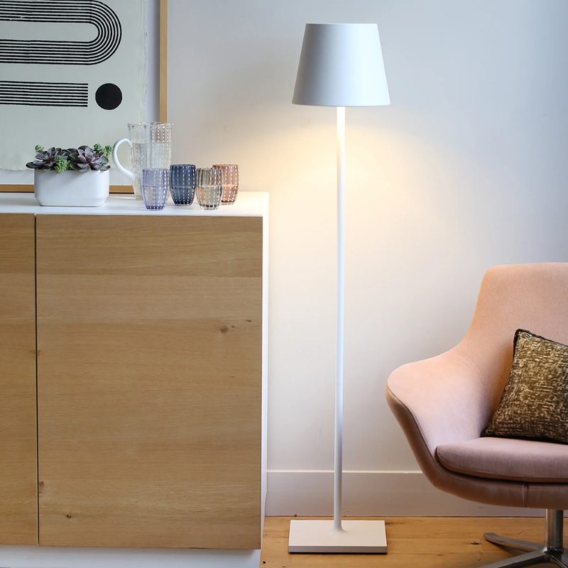 The white Poldina Pro XXL Floor Lamp from Zafferano in a living room.