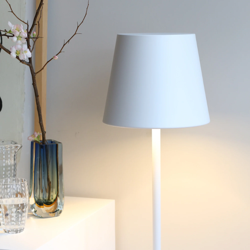 The white Poldina Pro XXL Floor Lamp from Zafferano in a lounge.