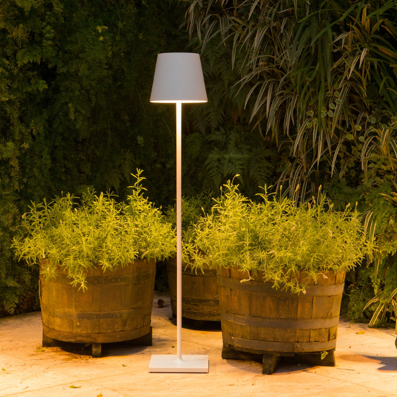 The white Poldina Pro XXL Floor Lamp from Zafferano in an outdoor living space.